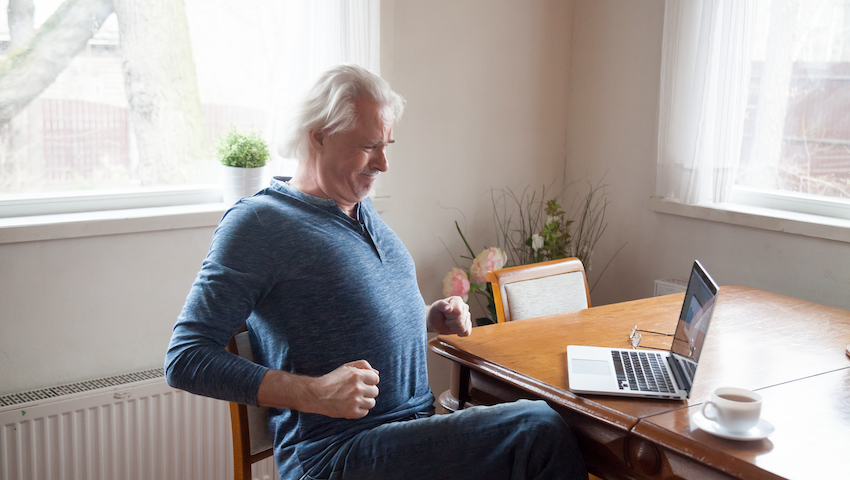 Man with back pain sitting at computer
