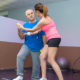 Physical therapist helping older man with balance