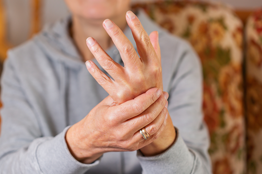 Woman with gout pain in hand