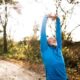 Senior stretching arms in nature