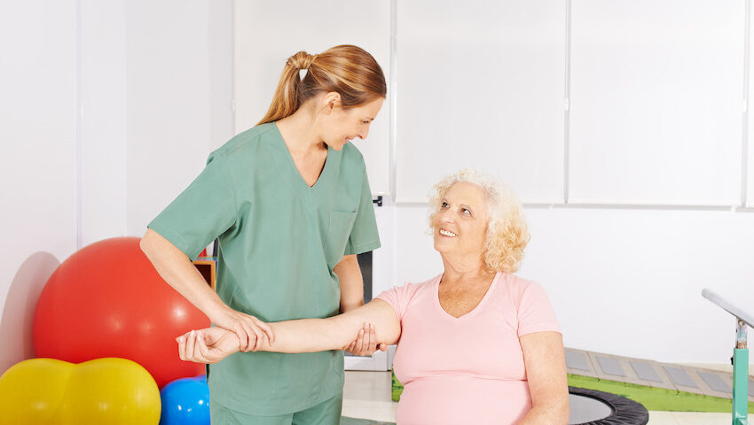 Older woman getting shoulder rehab therapy